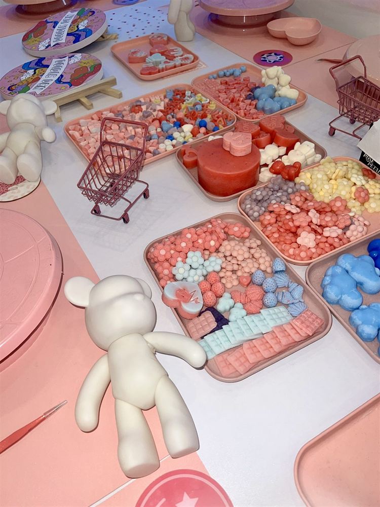 Trays of pastel beads and charms laid out ready for a workshop
